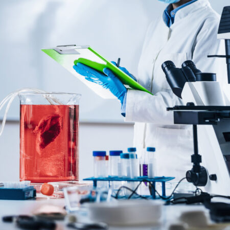 Cultured meat. female scientist taking notes in laboratory